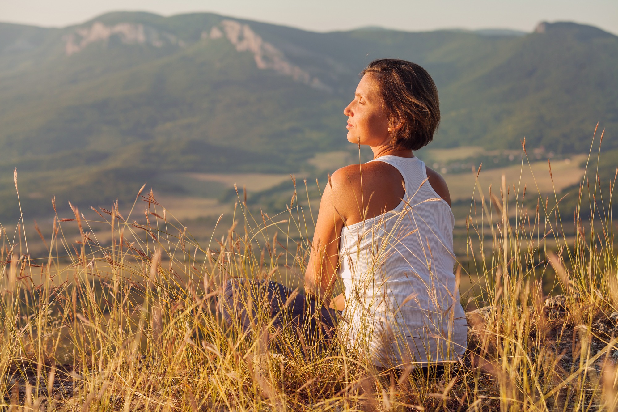 Sitting in meditation pose woman enjoyed
