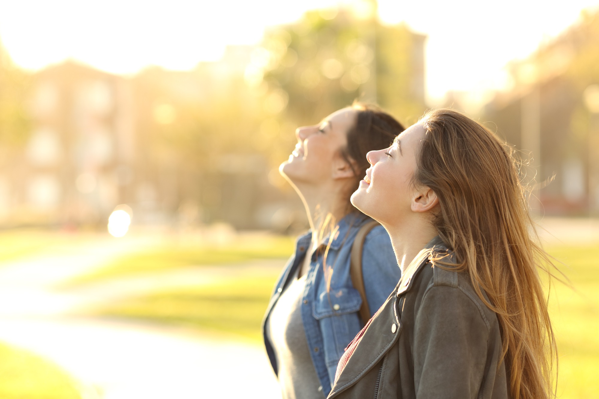 Side view portrait of two happy girls